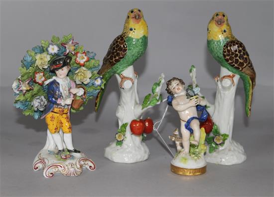 A pair of ceramic parrots, a boy holding a bird and a pastoral figure with basket (4)